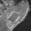 Oblique aerial view centred on the football ground with the school adjacent, taken from the SW.