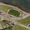 Oblique aerial view centred on the football ground, taken from the NW.