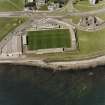 Oblique aerial view centred on the football ground, taken from the SSE.