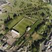 Oblique aerial view centred on the football ground, taken from the W.