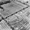 Mains of Glamis, oblique aerial view, taken from the NNE, showing the cropmark of a possible enclosure in the bottom left-hand corner, and further cropmarks across the bottom half of the photograph.