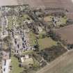 Oblique aerial view centred on the hospital and offices, taken from the WNW.