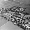 Oblique aerial view centred on the hospital and offices, taken from the NNW.