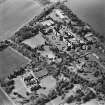 Oblique aerial view centred on the hospital and offices, taken from the ESE.