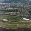 General oblique aerial view of Dundee centred on the hospital with the airport adjacent, taken from the S.