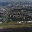 General oblique aerial view of Dundee centred on the hospital with airport adjacent, taken from the S.