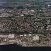 General oblique aerial view of Dundee centred on Greendykes Road, the church and Strips of Craigie Road, taken from the S.