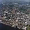 General oblique aerial view of Dundee centred on Westport roundabout with the railway station adjacent, taken from the ESE.