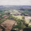 General oblique aerial view looking across the country house, ponds, stable block and farmsteading towards the Grampian mountains, taken from the SE.