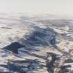 General oblique aerial view of the glen with the village adjacent and the Grampian Mountains in the distance, taken from the ESE.