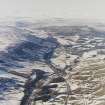 General oblique aerial view of the glen with the village adjacent and the Grampian Mountains in the distance, taken from the SE.