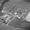 Oblique aerial view centred on the military camp with the bunker, observation post and remains of the church and graveyard adjacent, taken from the ESE.