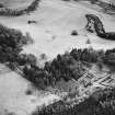 Oblique aerial view centred on the country house with farmsteading adjacent, taken from the N.