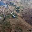 Oblique aerial view centred on the church and manse, taken from the NE.