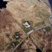 Oblique aerial view centred on the church and manse, taken from the SW.