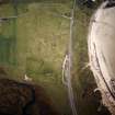 Oblique aerial view centred on the remains of the church and burial ground, taken from the SSW.