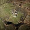 Oblique aerial view centred on the house, the farmsteading and the remains of the castle, taken from the SW