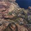 Oblique aerial view centred on the township and the remains of the buildings, taken from the NW.