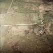 Oblique aerial view centred on the house and farmsteading, taken from the SSW.