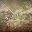 Oblique aerial view centred on the house and farmsteading, taken from the SE.