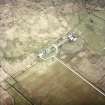 Oblique aerial view centred on the house and farmsteading, taken from the NW.