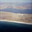 General oblique aerial view looking over the military installation towards Eochar and Benbecula beyond, taken from the SW.