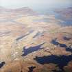 General oblique aerial view looking over the remains of the township, towards Lochboisdale and The Minch beyond, taken from the W.