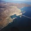 General oblique aerial view centred on the township with the causeway adjacent, taken from the SW.