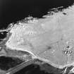 Oblique aerial view of Orkney, Rerwick Head, Rerwick Battery, taken from the NW.  Visible are the gun-emplacements, battery observation tower, searchlight platforms, concrete hut bases for the accommodation camp and two air-raid shelters cut into the shore..