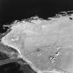 Oblique aerial view of Orkney, Rerwick Head, Rerwick Battery, taken from the W.  Visible are the gun-emplacements, battery observation tower, searchlight platforms, concrete hut bases for the accommodation camp and two air-raid shelters cut into the shore..