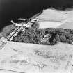 Oblique aerial view of Orkney, Shapinsay, Balfour Castle walled garden, Balfour village and harbour taken from the NW.  Also visible is the Dishan Tower dovecot.