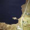 Oblique aerial view centred on remains of the broch with the possible crannog adjacent, taken from the ENE.