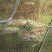 Oblique aerial view centred on the remains of the stone circle, stone alignments and chambered cairn, taken from the WNW.