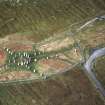 Oblique aerial view centred on the remains of the stone circle, stone alignments and chambered cairn, taken from the SE.