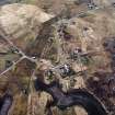 Oblique aerial view centred on the school and the remains of the buildings, taken from the E.