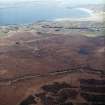 General oblique aerial view looking across the peat cutting and the remains of the chambered cairn towards the modern crofting township of Aird Thunga, taken from the NW.