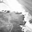 Oblique aerial view centred on the remains of the lazy beds and possible promontory fort with the dun and possible shieling-hut, adjacent, taken from the SSW.