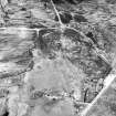 Dremergid, oblique aerial view, taken from the SW, centred on an area defined as an archaeological landscape, burnt mounds and an area with a hut-circle, small cairns and a bank. The remains of a building is visible in the bottom left-hand corner of the photograph.
