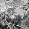 Dremergid, oblique aerial view, taken from the NW, centred on an area defined as an archaeological landscape, and burnt mound. A building and a farmstead is visible in the top right-hand corner of the photograph, and a hut-circle, bank and small cairns, as well as a fieldsystem, hut and hut-circle is shown in the top left-hand corner area..