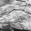 Oblique aerial view of the remains of the hut-circles, enclosures, small cairns and field system, taken from the NW.