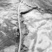 Oblique aerial view of the remains of the hut-circles, enclosures, small cairns and field system, taken from the N.