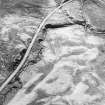 Oblique aerial view of the remains of the hut-circles, enclosures, small cairns and field system, taken from the NNW.