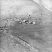 Oblique aerial view centred on the remains of the farmstead, taken from the SE.