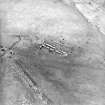 Oblique aerial view centred on the remains of the farmstead, taken from the SE.