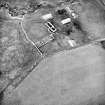 Oblique aerial view centred on the remains of the farmstead, taken from the SE.