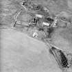 Oblique aerial view centred on the remains of the farmstead, taken from the E.