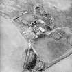 Oblique aerial view centred on the remains of the farmstead, taken from the NE.