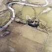 Oblique aerial view centred on the farmstead and the remains of the building, taken from the NE