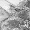 Oblique aerial view centred on the farmsteading, taken from the W