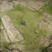 Oblique aerial view centred on the remains of the broch, rig and lazy bedding, taken from the NE.